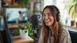  Woman podcaster make audio podcast with headphones and microphone in her home art studio.