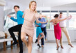 © JackF - Group is of different ages active people engaged in Latin dance studio and learns movements of cha-cha-cha dance