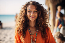 Generative AI Image Of A Relaxed Cheerful Young Woman With Curly Hair Smiling Looking At Camera, Dressed In A Vibrant Orange Top Enjoying A Beautiful Sunny Day At The Beach