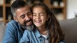 portrait of caring father embracing happy girl