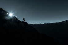 Mountaineer On Rocky Ledge With Sun Star, In The Background South Tyrolean Mountains, Naturns, South Tyrol, Italy, Europe