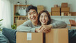 © Sasint - Happy asian young attractive couple man and woman with big boxes moving into a new house, new apartment for couple the new home, Moving house. on sofa
