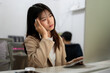 © bongkarn - A tired and overworked Asian businesswoman is working on her project on computer in the office.