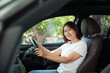 © nichapa - Asian women driving a car and smile happily
