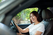 © nichapa - Asian women driving a car and smile happily