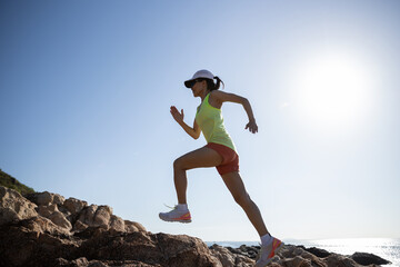 Sticker - Woman runner running on sunrise seaside rocky mountains