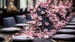 A stylish and modern birthday party with a sophisticated color scheme. The table is adorned with elegant floral arrangements, sleek tableware, and a stunning tiered cake as the centerpiece