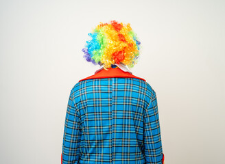 Wall Mural - Rear view Mr Clown. Back behind Portrait of Funny comedian face Clown man in colorful uniform wearing wig standing. Happy expression male bozo in various pose on isolated background.