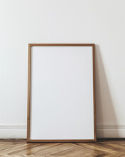 Mockup Of A Blank Large Light Oak Frame Leaning Against A White Wall.