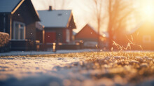 A Suburban Home On A Winter Morning, With The Warmth Of The Sunrise Melting The Frost On The Grass.