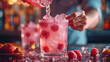 Close-up of barman making cocktail with fresh raspberries