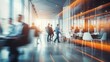 © Ashi - Dynamic business professionals in energetic motion: team meeting in a spacious hall with abstract blurred office interior in vibrant blue and orange tones
