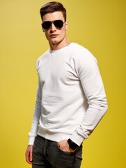 Wall Mural - Portrait of handsome man with sunglasses wearing white Sweatshirt and dark grey jeans with short hairstyle cut isolated on yellow background