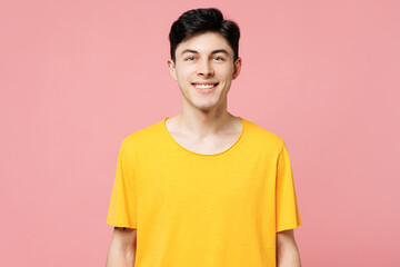 Poster - Young smiling happy cheerful fun cool Caucasian man he wears yellow t-shirt casual clothes looking camera isolated on plain pastel light pink color wall background studio portrait. Lifestyle concept.