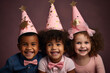 Happy children with birthday hats. Studio shot on a dark background. play game together, celebrate festive event,  Childhood and celebration