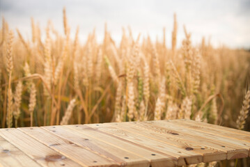 Wall Mural - Wooden Plank Empty Table For Products Display With Blurred Wheat Field and Blue Sky Background. High quality photo