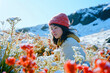 Lonely woman in a red hat against the backdrop of a winter landscape