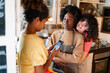 © NDABCREATIVITY - Multiethnic homosexual female lesbian couple with daughter spending time together at home