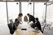 © fizkes - Diverse project team planning work strategy on meeting, reviewing statistic reports, talking over financial documents at large table, brainstorming on startup management