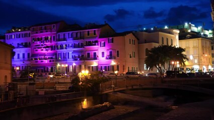 Poster - Sanremo at night with colorful buildings along the port