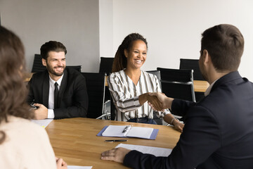 Poster - Male boss giving handshake to best manager woman, discussing project success with multiethnic team, thanking partner for cooperation, help, reaching agreement with partner, client, investor