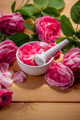 Wall Mural - rose essential oil, pink rose SPA and aromatherapy. Selective focus