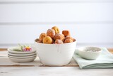 Fototapeta Kuchnia - variety of donut holes in a white ceramic bowl