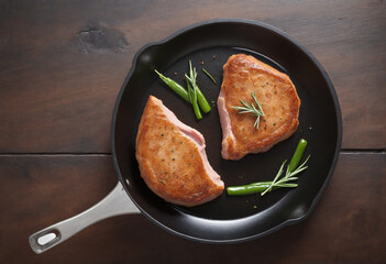 Wall Mural - Top view of pork chops fried in a skillet