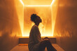 A person sitting in an infrared sauna surrounded by soft, warm light.