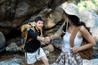 © itchaznong - Happy LGBT Lesbian couple Travelers Hiking with Backpacks in waterfall Trail. LGBT Lesbian Couple Hikers with backpacks walks in mountains in vacation