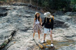 © itchaznong - Happy LGBT Lesbian couple Travelers Hiking with Backpacks in waterfall Trail. LGBT Lesbian Couple Hikers with backpacks walks in mountains in vacation