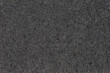 Texture of black hard synthetic material of kitchen cleaning sponge