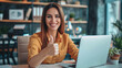 © Kowit - Happy Professional Woman Giving Thumbs Up. Smiling businesswoman giving a thumbs up in a modern office setting.