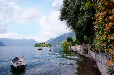 Wall Mural - Beautiful scene of lake Como in Italy. A big blue lake surrounded by green hill.