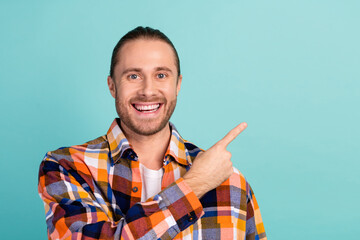 Sticker - Portrait of pleasant guy with beard long hairdo wear flannel shirt indicating at sale empty space isolated on turquoise color background