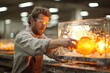 A man is a glassblower working in a glass factory where products are created manually