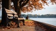 Bench in the park near the lake shore. The fall season, fallen leaves. Generative ai