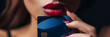 Close-up of woman holding bank credit or debit card in front of her lips, extorsion concept, keeping mouth shut,