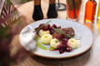 Traditional Silesian potato dumplings with roasted meat in gravy and beetroots. Polish style lunch at a restaurant. 
