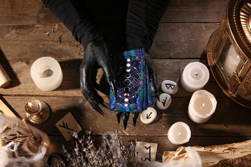 Wall Mural - Witch with tarot cards on dark wooden table, top view