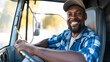 © Artistic Visions - a black male truck driver smiling while driving a truck