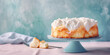 Angel Food Cake on Pastel blue background with copy space.  Elegant fluffy sponge Angel Food Cake on a cake, perfect for high tea or dessert.