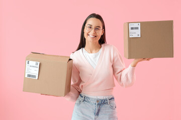 Wall Mural - Female seller with parcels on pink background