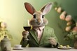 Leinwandbild Motiv Easter bunny in a business suit with a glass of red wine on a table on a blurred background