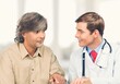 © BillionPhotos.com - A professional doctor man sharing information to patient.