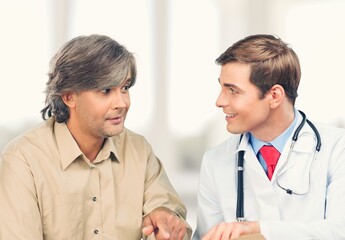 Wall Mural - A professional doctor man sharing information to patient.