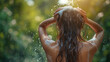 A young woman washing her hair has foam flowing from the top. Hair and scalp care