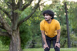 © Tetiana - Young indian man taking a break after exercising in a green park, fitness and wellness concept