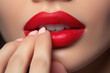 © pilipphoto - Close up view of beautiful woman lips with red lipstick. Cosmetology, drugstore or fashion makeup concept.