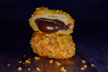 Poster - Roti goreng or fried bread with chocolate filling. sliced, on a wooden table.